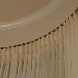 White Drapes on Curved Curtain Rod