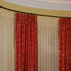 Red & White Drapes on Curved Curtain Rod