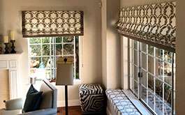 Patterned Roman Shades & Window Cushion in Living Room