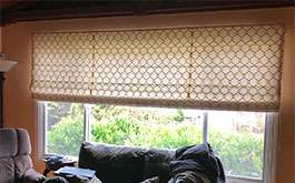 livingroom geometric patterned soft fold roman shades partially closed