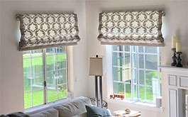 residential living room corner windows floral pattern soft fold roman shades open